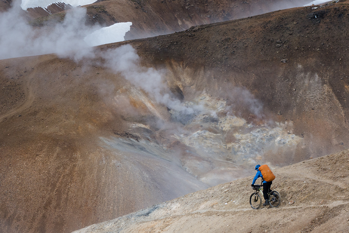Day 3 backpacking between Thorsmork and Landmannalaugar, Iceland. Adam riding among volcanic steam vents above Alftavatn.