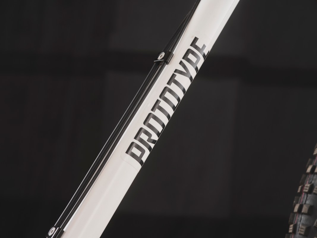 Close-up of a bicycle frame showing the word 'PROTOTYPE' printed on the downtube.