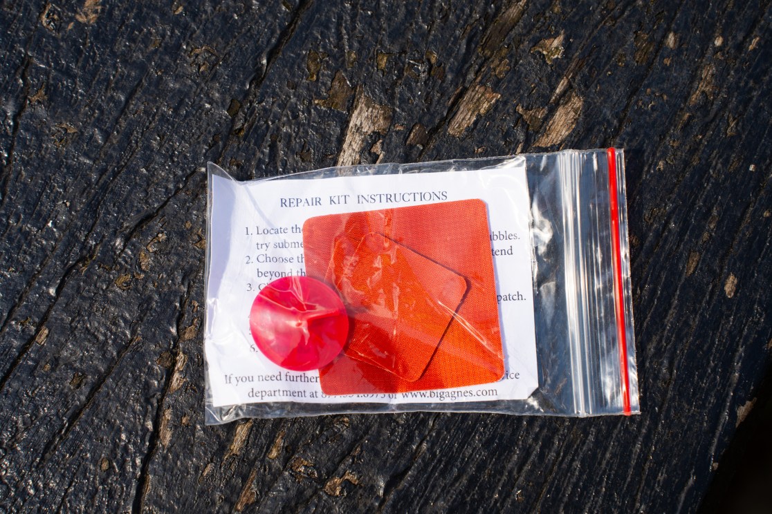 Repair kit for inflatable mats featuring patches and adhesive, packaged in a clear plastic bag with instructions.