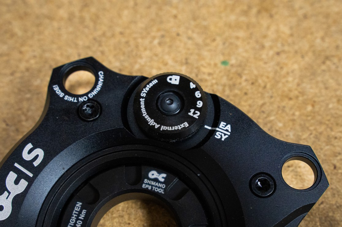 Close-up of a Shimano EP8 tool adjustment dial with numbered settings and labels for easy and hard settings on a black component.