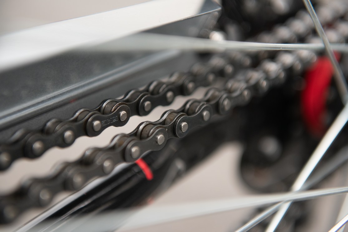 Close-up view of a bicycle chain with metal links and a shiny finish.