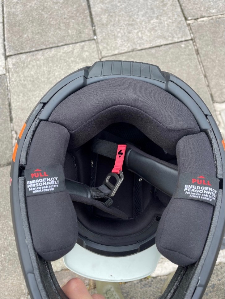 Interior view of the Sweet Protection Fixer helmet, showcasing the padded lining, chinstrap, and emergency removal tags.