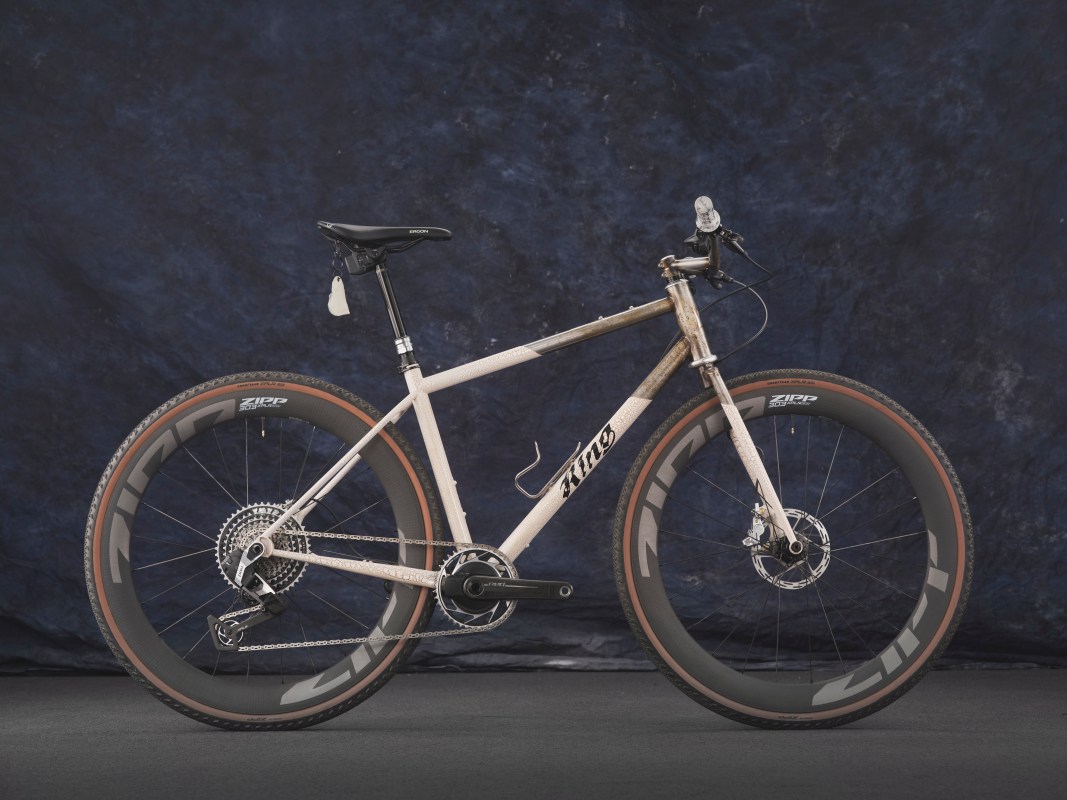 A custom mountain bike with unique design features, including large tires and a distinctive frame, presented against a dark blue background.